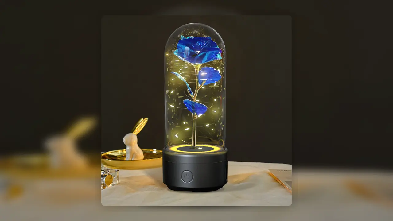 Bluetooth Rose Speaker Lamp glowing under a glass dome on a bedside surface