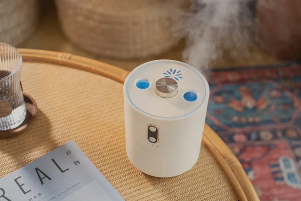 Cauora Volcano Flame Diffuser releasing mist with a softly blurred warm background