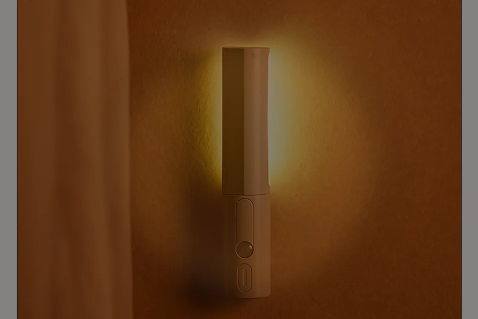 Cauora Soft Motion Night Light glowing at baseboard height in a hallway
