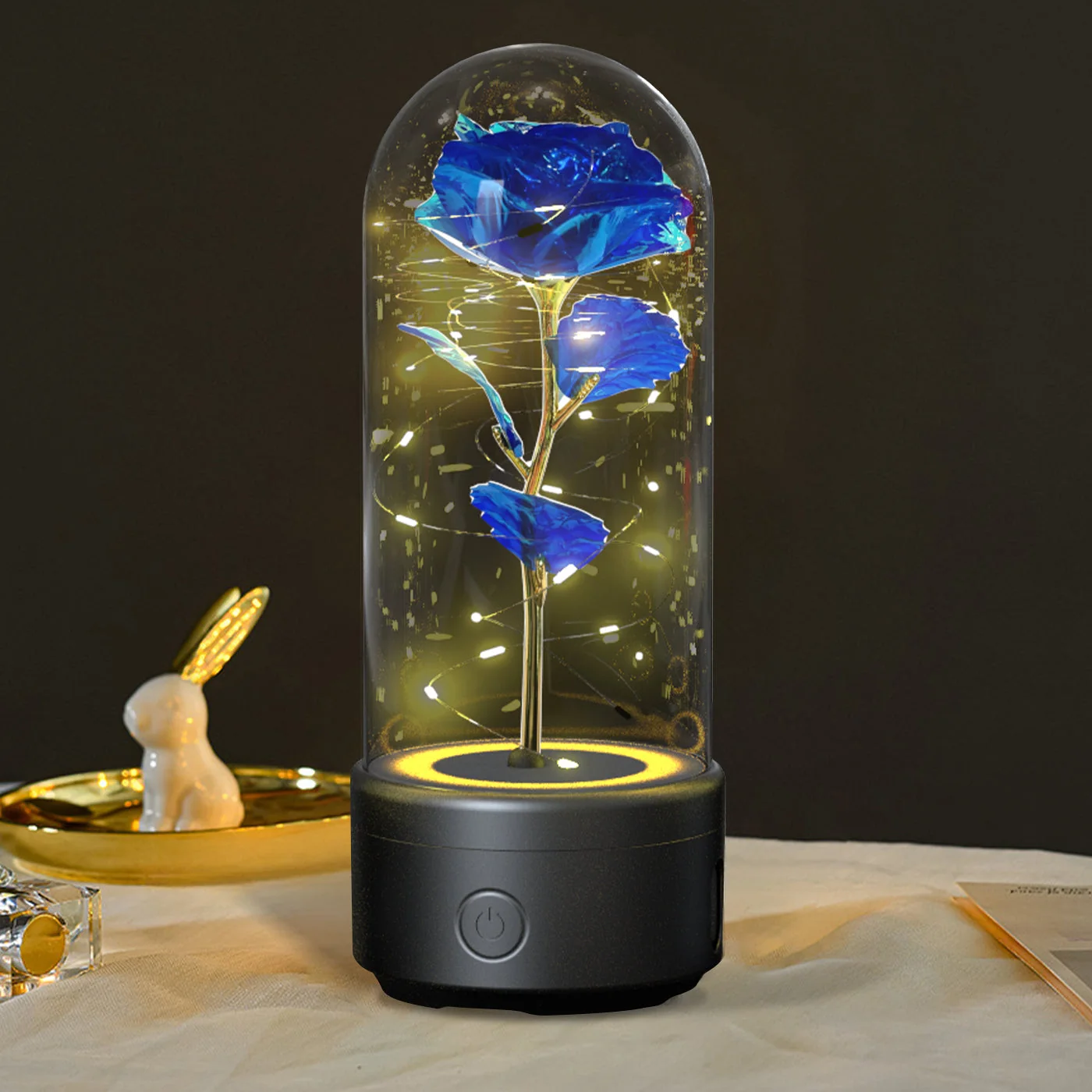 Blue rose Bluetooth speaker lamp glowing under a glass dome on a black base
