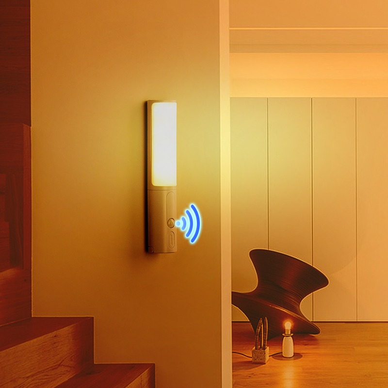 Motion-sensing night light glowing along a hallway wall
